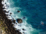 overhead view of blue sea and rock edge overhead view of blue sea and rock edge