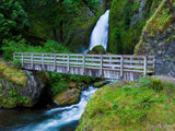 bridge over the creek with waterfall in background bridge over the creek with waterfall in background