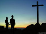 couple standing before the cross couple standing before the cross