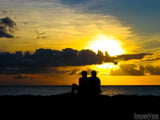 a couple at sunset on a beach a couple at sunset on a beach
