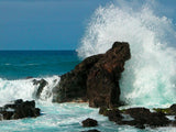 waves crash over rock formation creating spray waves crash over rock formation creating spray