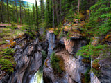 deep black canyon walls with creek at bottom deep black canyon walls with creek at bottom