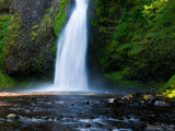 in the creek view of a background waterfall in the creek view of a background waterfall