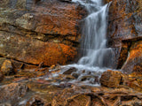 falls rolling over orange rocks falls rolling over orange rocks
