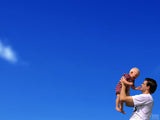 blue sky father holding up baby blue sky father holding up baby