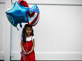 girl holding balloons fourth of July girl holding balloons fourth of July