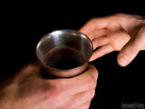 hands passing the communion cup hands passing the communion cup