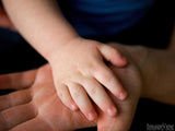 child's small hand on top of mans big hand child's small hand on top of mans big hand