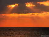 over head sun setting above the ocean over head sun setting above the ocean