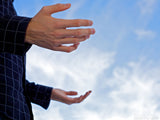 man lifts hands on blue sky background in his name man lifts hands on blue sky background in his name