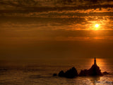 the sun setting on a english lighhouse the sun setting on a english lighhouse