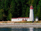 lighthouse with red roof by the waters edge lighthouse with red roof by the waters edge