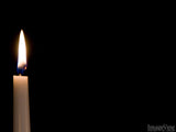 lit candle on black background lit candle on black background