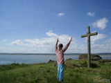 man before cross on holy island man before cross on holy island