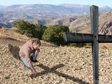 man kneeling at the foot of the cross man kneeling at the foot of the cross
