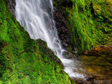 pool of cascading water and jagged moss rocks pool of cascading water and jagged moss rocks