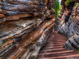 rock walls and a stone pathway lead down the mountain rock walls and a stone pathway lead down the mountain