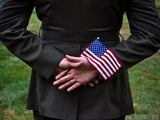 soldier stands holding flag soldier stands holding flag