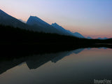 still waters with a background of mountains still waters with a background of mountains