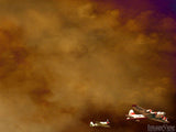 plane flying through sunset clouds plane flying through sunset clouds