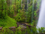 view through the waterfall at lush green valley view through the waterfall at lush green valley