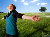 woman in field worships with arms out woman in field worships with arms out