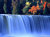 stream of wide waterfall in autumn colors
