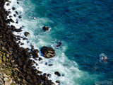 overhead view of blue sea and rock edge