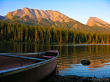 boat on the lake shore with mountains in background