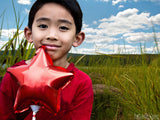 boy with red star balloon