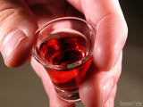 hand holding a cup of communion drink