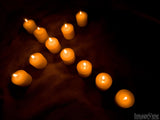 candles arranged in the shape of cross