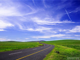 cross in clouds over green pasture background