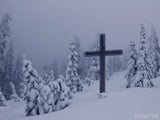 the snow backdrops this wood cross