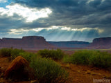 god rays coming through cloud at desert plateau