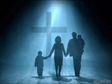 family in light at the cross