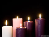 five advent pillar candles in purples whites and pink