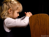 young girl praying in church