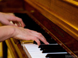 closeup of hands on piano keys