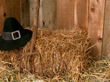 hay bale in barn with Amish hat