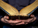 hands holding an open bible
