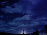 cross with sunlight in jerusalem on a dark blue sky background