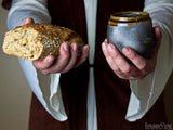 jesus holding communion cup and bread