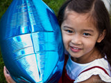 little girl hugs balloon
