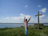 man before cross on holy island