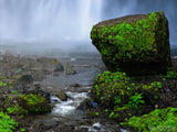 misty background from water fall and mossy rocks