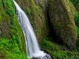mossy rocks with large rock and waterfall