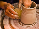 the potters working clay on the spinning wheel