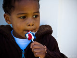 young boy with red white and blue candy