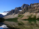rugged mountain reflects in clear lake